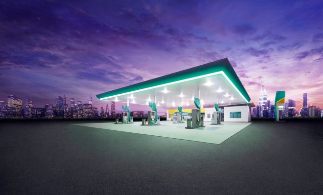 Petrol,Gas,Station,At,Night,With,City,Building