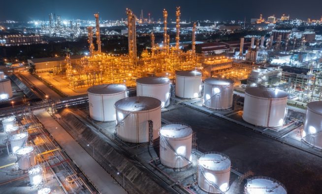 Glowing,Storage,Tanks,And,A,Labyrinth,Of,Pipes,Define,An